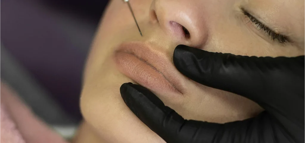 A woman receiving a skin laser treatment using a specialized machine in a serene spa environment.